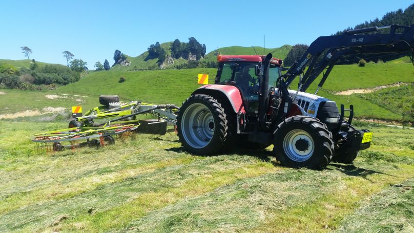 Case IH Puma 180 with rotary hay rake